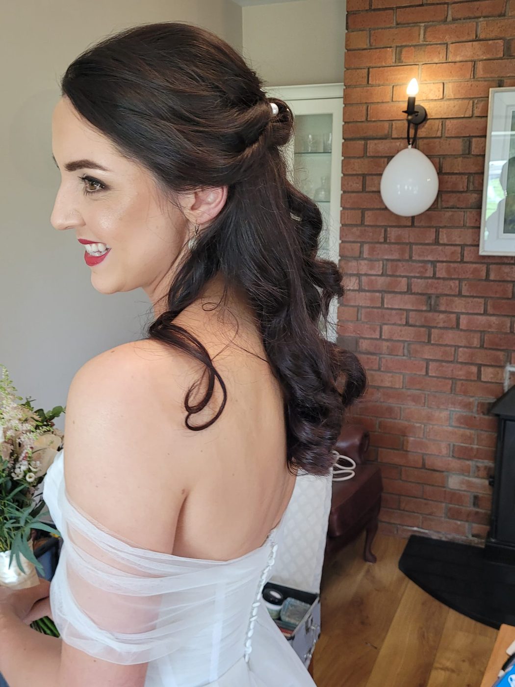 Half-up bridal style with soft curls, finished at INCH Hair Design